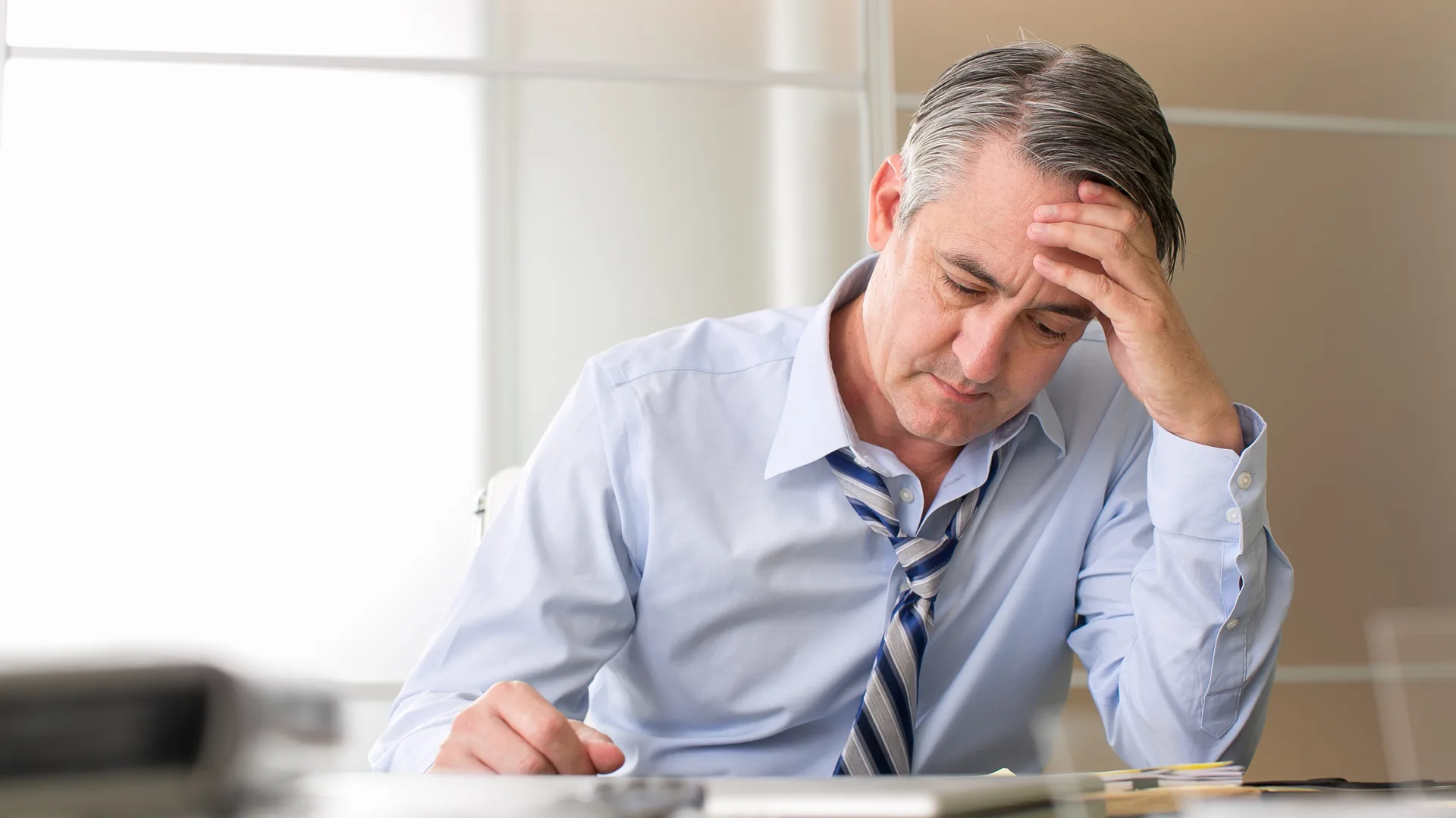 Stressed businessman at desk